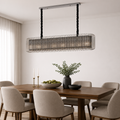 Dining room with a modern chandelier, wooden table, and chairs.
