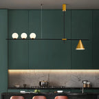 Modern kitchen with green cabinets, a gold pendant light, and marble countertop.