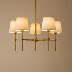 Modern chandelier with five lampshades on a beige background