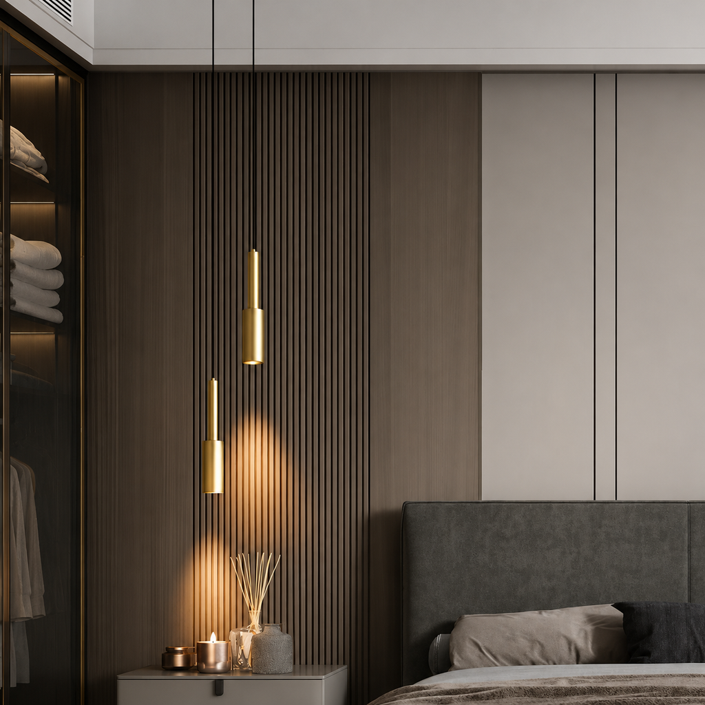 Modern bedroom with gray upholstered headboard, gold pendant lights, and a closet.