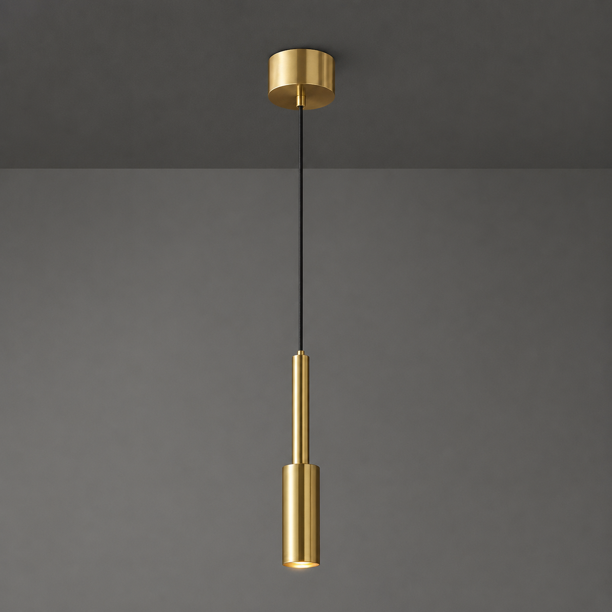 Gold pendant light fixture on a gray background