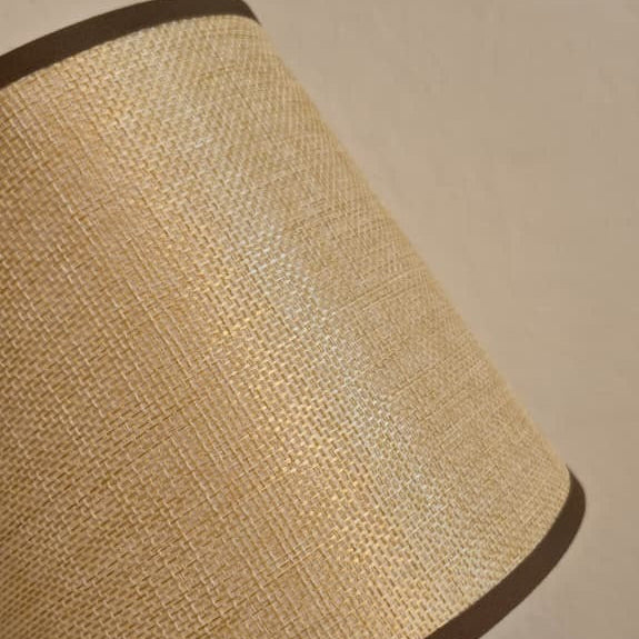 Textured beige lampshade against a beige wall
