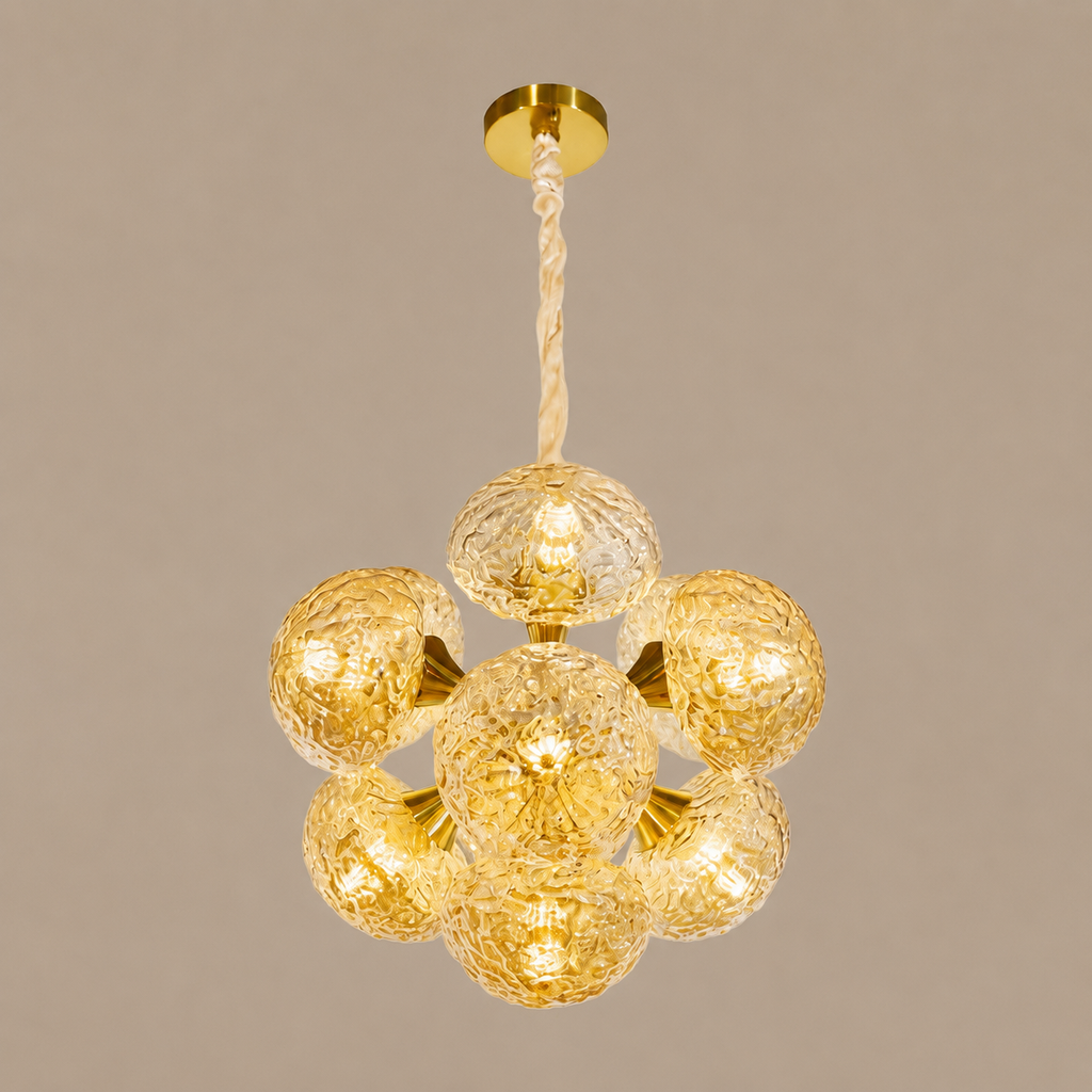 Gold chandelier with glass globes on a beige background