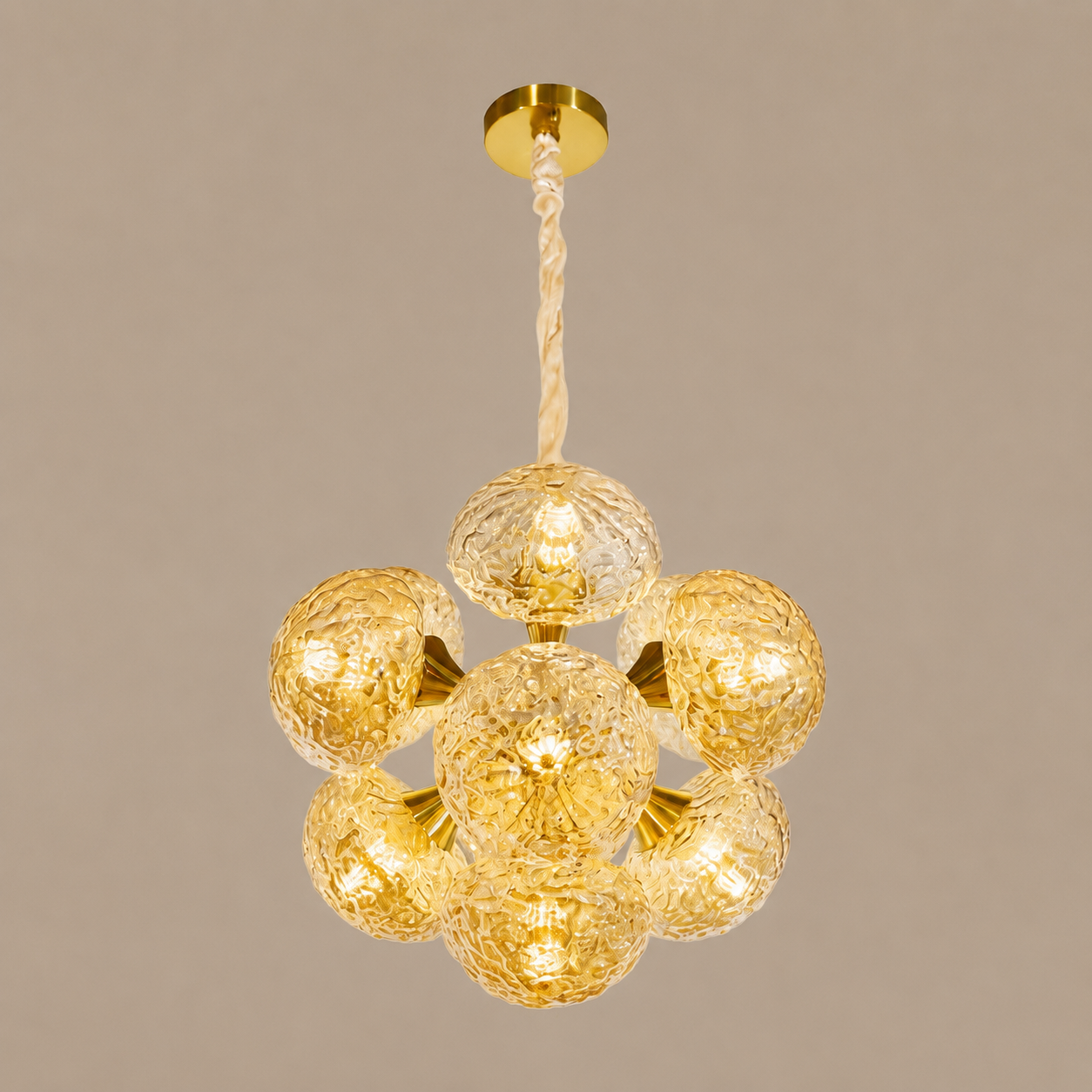 Gold chandelier with glass globes on a beige background