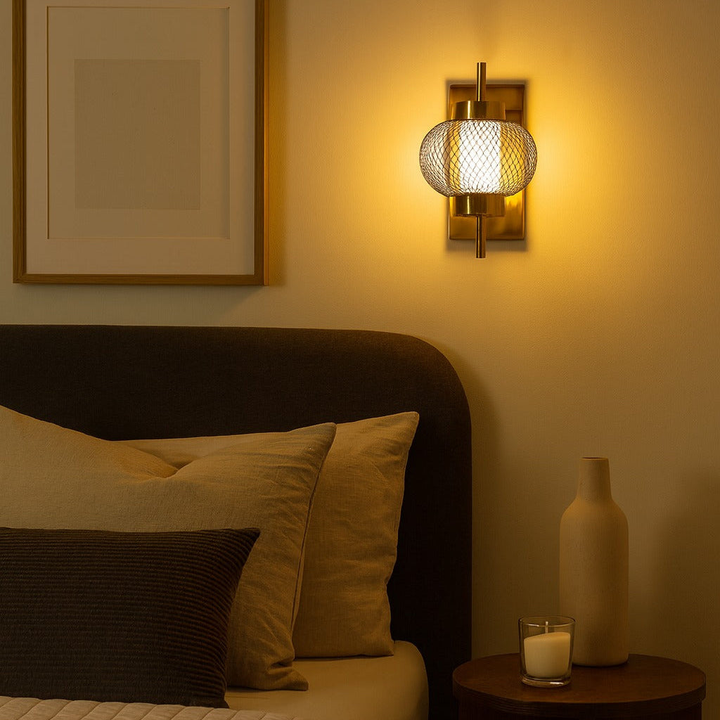 Bedroom with a bed, wall sconce, and side table with a candle.
