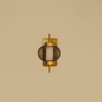 Gold wall sconce with mesh design on a beige background