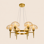 Gold chandelier with glass globe lights on a beige background
