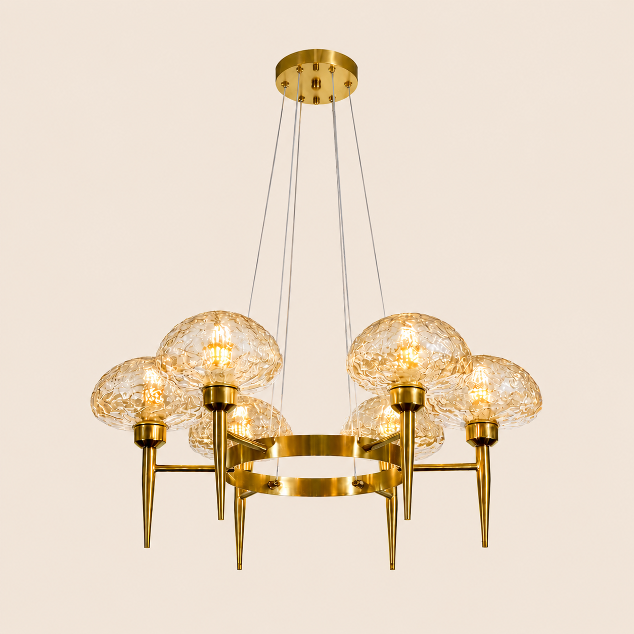 Gold chandelier with glass globe lights on a beige background