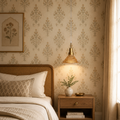 Cozy bedroom with floral wallpaper, wooden bed, and nightstand with lamp.
