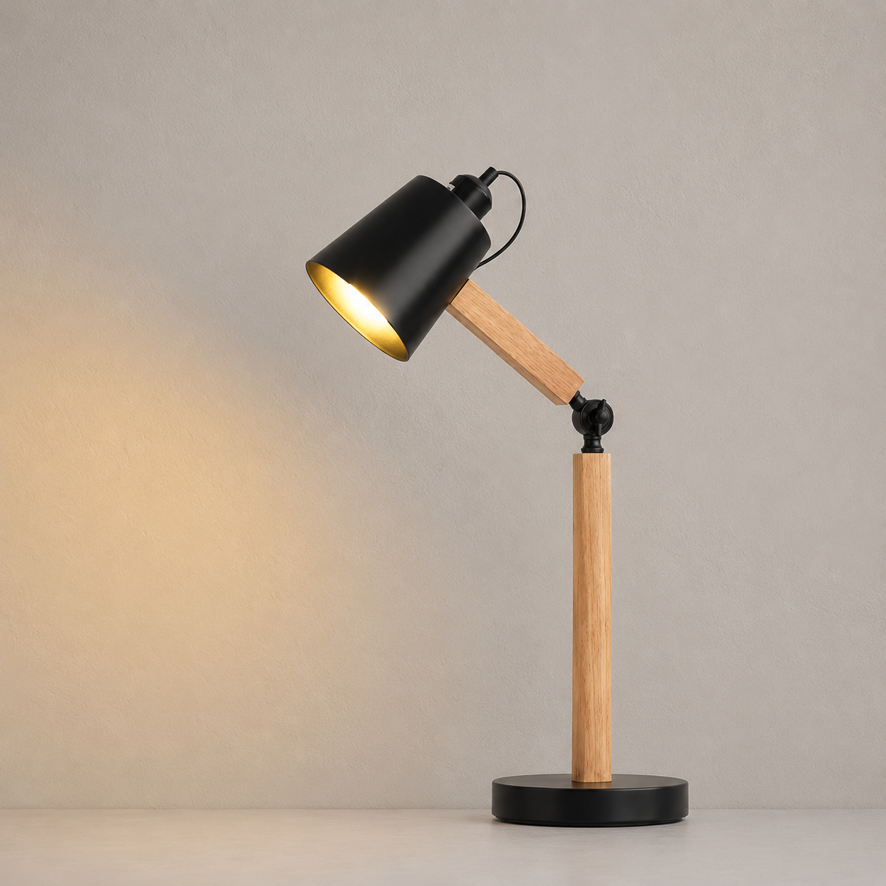 Table lamp with black shade and wooden arm on a neutral background