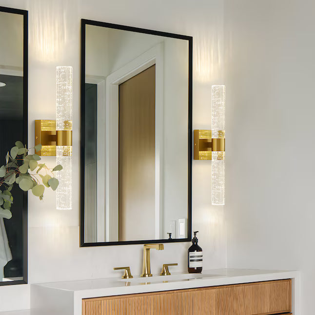 Bathroom vanity with mirror, lights, and decorative elements.