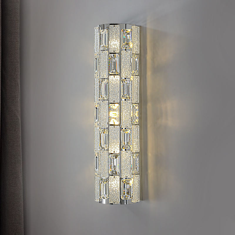 Decorative wall sconce with crystal-like design on a gray wall.