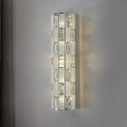 Decorative wall sconce with crystal-like design on a gray wall.