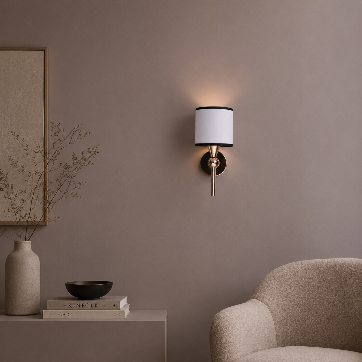 Wall sconce on a beige wall with a chair and decor items in the foreground