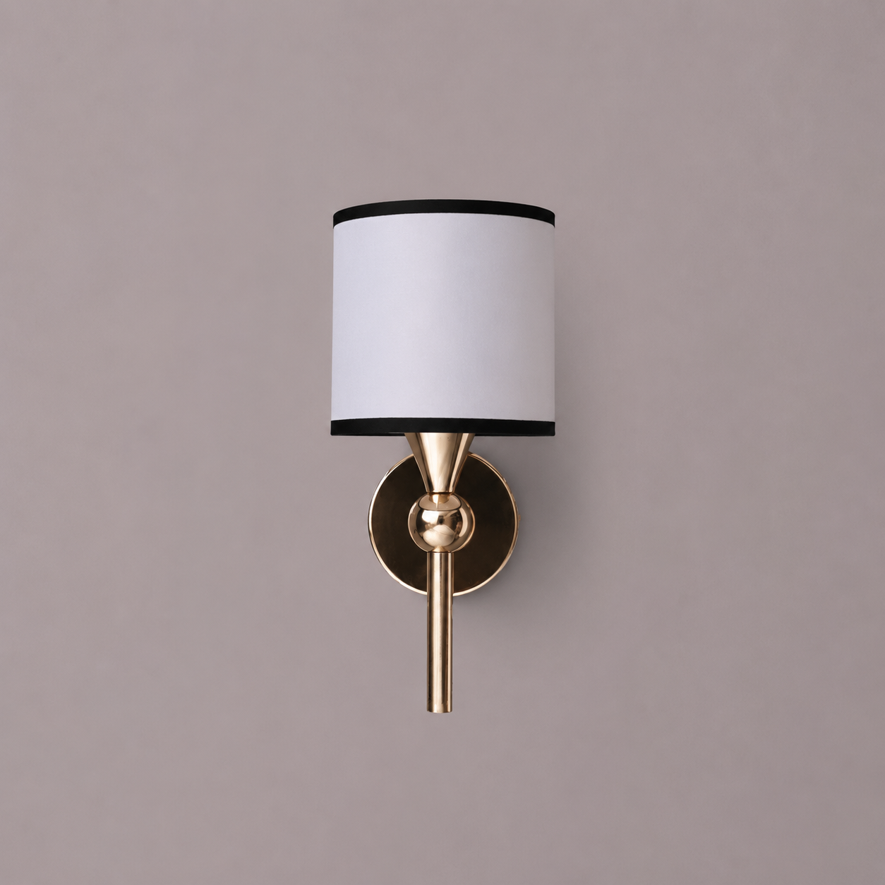 Wall sconce with white shade and gold fixture on a gray background
