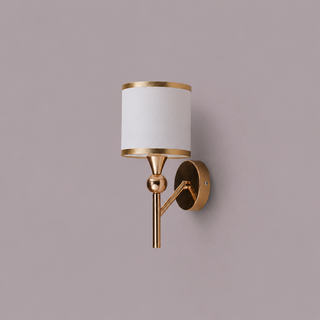 Wall-mounted lamp with gold fixture and white shade on a purple background